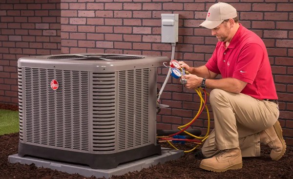 Professional HVAC technician servicing air conditioning unit